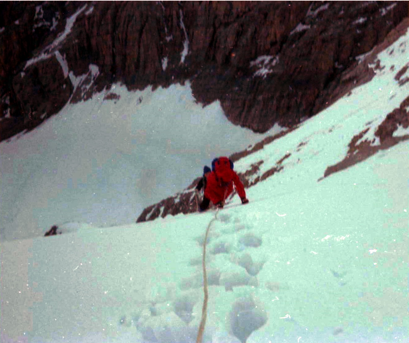 Climbing upper snow slopes above rock tower on ascent of the Ortler ( Cima Ortles )